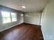Inviting living room featuring hardwood floors, a front door, and a large window at 120 Tower Dr, Statesville, NC 28677