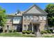 Attractive brick townhome with manicured landscaping and a welcoming front entrance with a black door at 12421 Fiorentina St, Charlotte, NC 28277