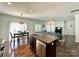 Open-concept living area showcasing the modern kitchen with stainless steel appliances, dining area, and a spacious living room at 12421 Fiorentina St, Charlotte, NC 28277