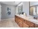 Bathroom with granite countertop, dual sinks, wooden drawers, decorative flowers, and large mirrors at 1325 Grantwood Nw Ave, Concord, NC 28027
