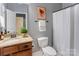 Well-lit bathroom featuring a vanity with granite counters and a shower with curtain rod at 1325 Grantwood Nw Ave, Concord, NC 28027
