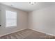 A bedroom with neutral carpet and large window bringing in natural light at 1325 Grantwood Nw Ave, Concord, NC 28027