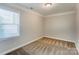 Cozy bedroom featuring a large window allowing ample natural light at 1325 Grantwood Nw Ave, Concord, NC 28027