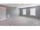 Spacious bonus room featuring neutral walls, carpet, two windows, and ample natural light at 1325 Grantwood Nw Ave, Concord, NC 28027
