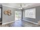 Bright dining area with sliding glass doors to the backyard, stylish light fixture, and wood floors at 1325 Grantwood Nw Ave, Concord, NC 28027