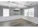 Bright dining room with coffered ceilings, wainscoting, wood floors, and a modern chandelier at 1325 Grantwood Nw Ave, Concord, NC 28027