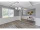 Bright dining room featuring wood floors, wainscoting, and a decorative bench at 1325 Grantwood Nw Ave, Concord, NC 28027