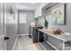 A well-organized laundry room with gray walls, washer, dryer, and folding table at 1325 Grantwood Nw Ave, Concord, NC 28027