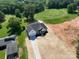 Stunning aerial view of the home with a long driveway, landscaped yard, and golf course in the background at 133 Harbourtown Dr, Kings Mountain, NC 28086