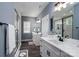 Bathroom with dual sinks, white cabinets, a glass shower, and modern lighting at 133 Harbourtown Dr, Kings Mountain, NC 28086