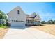 Beautiful new construction home with a welcoming front porch and attached two-car garage at 133 Harbourtown Dr, Kings Mountain, NC 28086