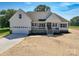 Charming new construction home featuring a welcoming front porch and attached two car garage at 133 Harbourtown Dr, Kings Mountain, NC 28086