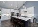 Bright kitchen with an island, white cabinets, stainless steel appliances, and pendant lighting at 133 Harbourtown Dr, Kings Mountain, NC 28086