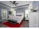 This is a spacious main bedroom with a ceiling fan, lots of light, and a red rug on wood floors at 133 Harbourtown Dr, Kings Mountain, NC 28086
