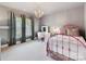 Stylish bedroom featuring a pink metal bed frame, makeup vanity, and ample natural light at 15009 Fanning Manor Ct, Charlotte, NC 28277