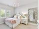 Cozy bedroom with a white bed, shuttered windows, and a large decorative mirror at 15009 Fanning Manor Ct, Charlotte, NC 28277