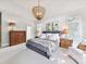 Bright bedroom featuring a statement chandelier, shuttered windows, and a comfortable bed with decorative pillows at 15009 Fanning Manor Ct, Charlotte, NC 28277