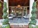 Inviting covered patio with outdoor seating and a stylish rug at 15009 Fanning Manor Ct, Charlotte, NC 28277