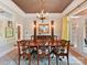 Dining room with large table, chandelier, crown molding, and access to outdoor area at 15009 Fanning Manor Ct, Charlotte, NC 28277