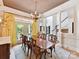 Open dining room with large windows, chandelier, and view of the foyer and staircase at 15009 Fanning Manor Ct, Charlotte, NC 28277