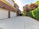 Spacious concrete driveway leading to a two-car garage of the brick home at 15009 Fanning Manor Ct, Charlotte, NC 28277
