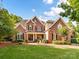 Stately brick home with well-manicured lawn and inviting entrance at 15009 Fanning Manor Ct, Charlotte, NC 28277