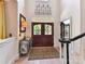 Elegant foyer features a stylish front door, decorative wrought iron detail, and beautiful flooring at 15009 Fanning Manor Ct, Charlotte, NC 28277