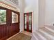 Close-up of foyer featuring elegant front doors, stairs, and a decorative area rug at 15009 Fanning Manor Ct, Charlotte, NC 28277