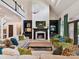 Open living room with fireplace, built-in shelving, high ceilings, and comfortable seating at 15009 Fanning Manor Ct, Charlotte, NC 28277