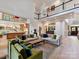 Open-concept living room with high ceilings, a fireplace, and a seamless transition to the kitchen at 15009 Fanning Manor Ct, Charlotte, NC 28277