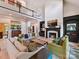 Spacious living room boasts high ceilings, a fireplace, and an open layout with balcony views at 15009 Fanning Manor Ct, Charlotte, NC 28277