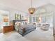 Serene main bedroom boasts natural light, plush carpet, and elegant decor and a sitting area at 15009 Fanning Manor Ct, Charlotte, NC 28277
