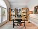 Well-lit home office with built-in shelving, a modern desk, and stylish window shutters at 15009 Fanning Manor Ct, Charlotte, NC 28277