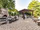 Charming outdoor kitchen area with a pergola and stone fireplace at 15009 Fanning Manor Ct, Charlotte, NC 28277