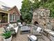 Cozy outdoor living space with a stone fireplace and comfortable seating at 15009 Fanning Manor Ct, Charlotte, NC 28277