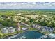 Breathtaking aerial view showcasing waterfront condos, green trees, pool, and boat docks at 17431 Tuscany Ln, Cornelius, NC 28031