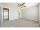 Bedroom with neutral carpeting and paint offers access to an en-suite bathroom at 17431 Tuscany Ln, Cornelius, NC 28031