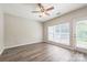 Well-lit bedroom featuring wood floors, large window, and door leading to outdoor space at 17431 Tuscany Ln, Cornelius, NC 28031