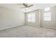 Bright bedroom featuring multiple windows and neutral carpeting at 17431 Tuscany Ln, Cornelius, NC 28031