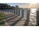 Wooden dock with rope railing with a view of the lake and neighborhood on a sunny day at 17431 Tuscany Ln, Cornelius, NC 28031