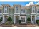 Charming townhouse exterior with light green siding, white trim, symmetrical shrubbery, and a welcoming entrance at 17431 Tuscany Ln, Cornelius, NC 28031