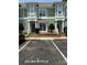 Charming townhome exterior featuring a lush landscaped entrance and assigned parking space at 17431 Tuscany Ln, Cornelius, NC 28031