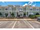 Charming townhome complex with a neat lawn, trimmed shrubs and nearby parking for easy access at 17431 Tuscany Ln, Cornelius, NC 28031
