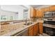 Updated kitchen with granite countertops, stainless steel appliances, tile backsplash and wood cabinets at 17431 Tuscany Ln, Cornelius, NC 28031
