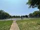 Community tennis court with well-maintained surface and surrounding trees at 17431 Tuscany Ln, Cornelius, NC 28031