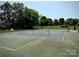 Community tennis court, featuring a well-kept court surrounded by trees and grass at 17431 Tuscany Ln, Cornelius, NC 28031