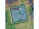 Overhead shot of well-maintained tennis courts surrounded by green spaces at 17431 Tuscany Ln, Cornelius, NC 28031