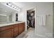 Bathroom featuring double sinks, granite counters, walk-in closet and neutral colors at 2000 Taney Way, Indian Land, SC 29707