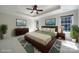 Staged bedroom featuring a ceiling fan, tray ceiling, and well-lit space at 2000 Taney Way, Indian Land, SC 29707