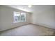 Bright bedroom with large window offering scenic views and ample natural light at 2000 Taney Way, Indian Land, SC 29707